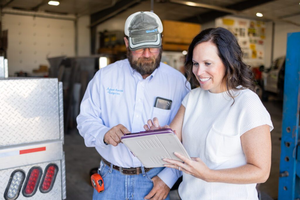 employee reviewing project details with client on tablet in Lincoln, Nebraska