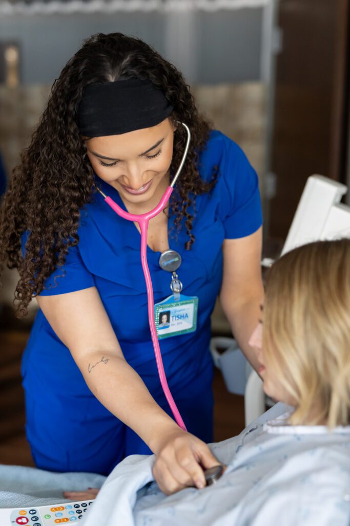 nurse using stethoscope to monitor patient during clinical care brand photography session