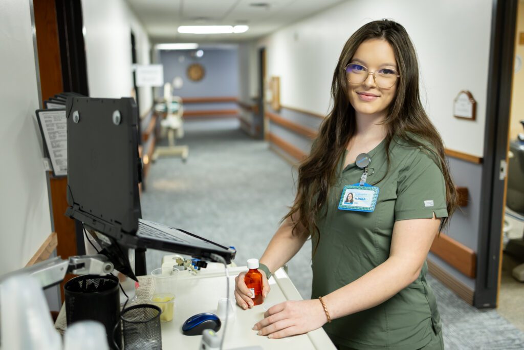 healthcare professional working at station in clinic hallway during brand photography session