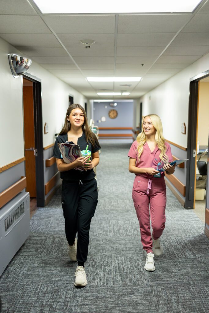 healthcare professionals walking through hospital hallway during workday