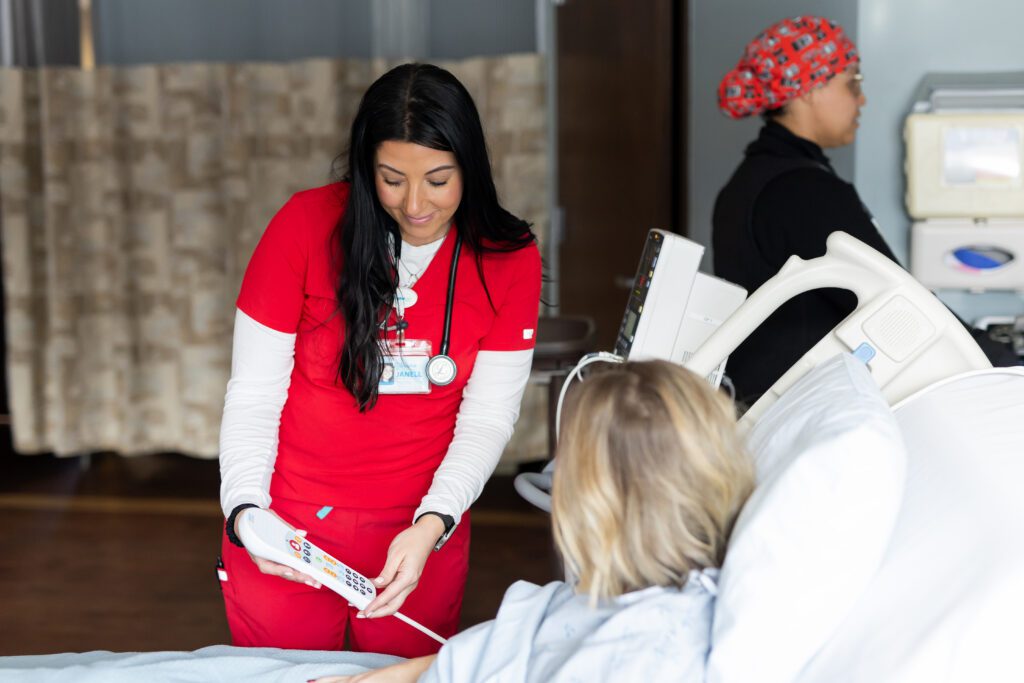nurse explaining medical device to patient during healthcare brand photography session