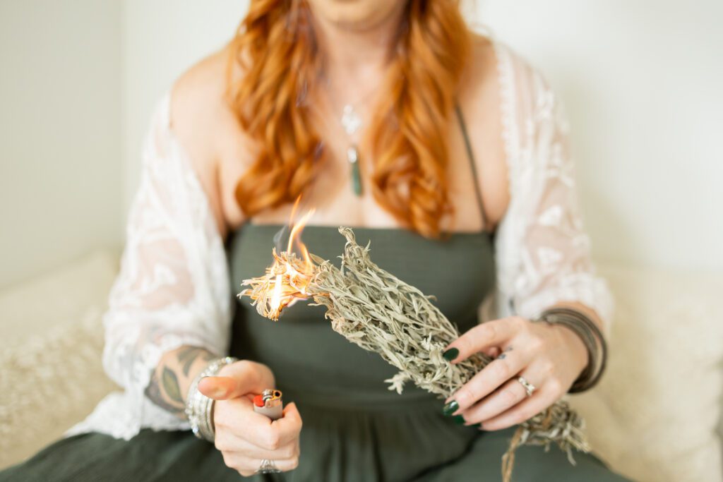 wellness practitioner lighting sage during brand photography session