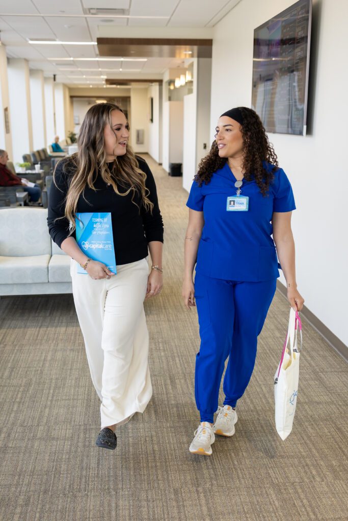healthcare professionals discussing work while walking through hallway