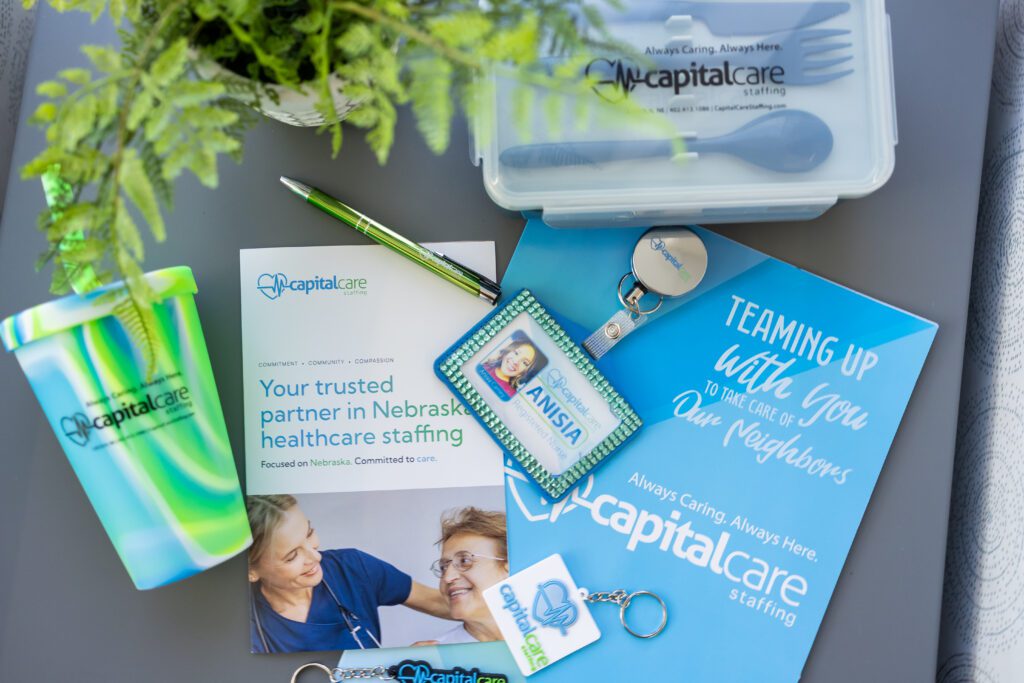 flat lay of healthcare branding materials including brochures, badge, and branded items