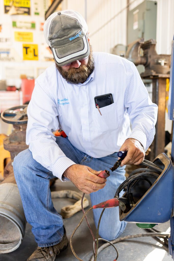 technician repairing cables and tools in workspace