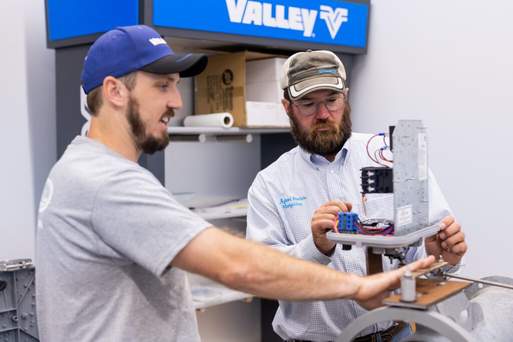 technicians working on irrigation system components