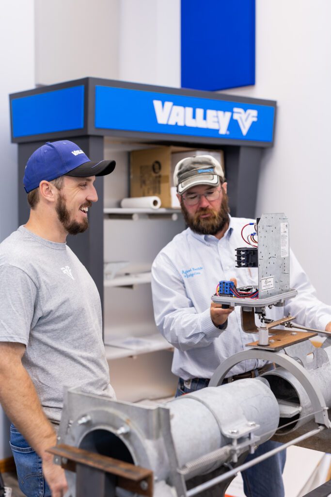 team collaborating on mechanical equipment during brand photography