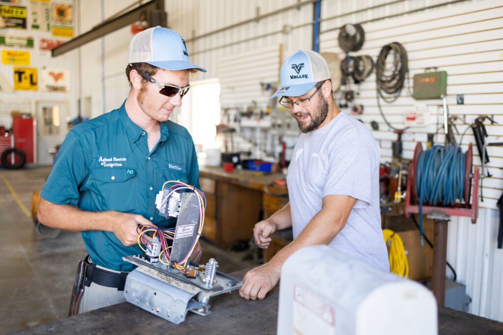 technicians reviewing electrical components in workshop in Lincoln, Nebraska